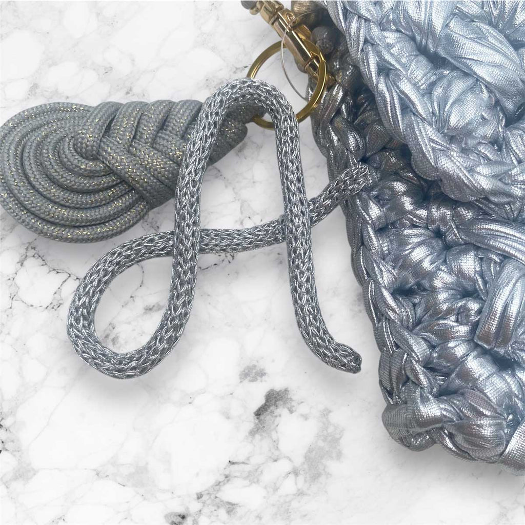 Borsa pochette in fettuccia argento con ciondolo charm iniziale personalizzato