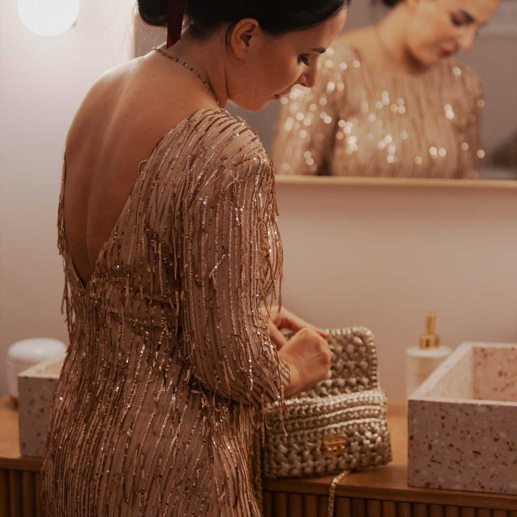 Borsa pochette all'uncinetto in fettuccia metallizzata oro rosa