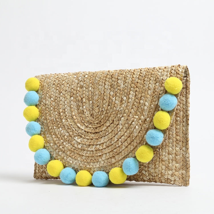 Pochette in paglia Ibiza con scritta personalizzata e pon pom gialli/azzurri