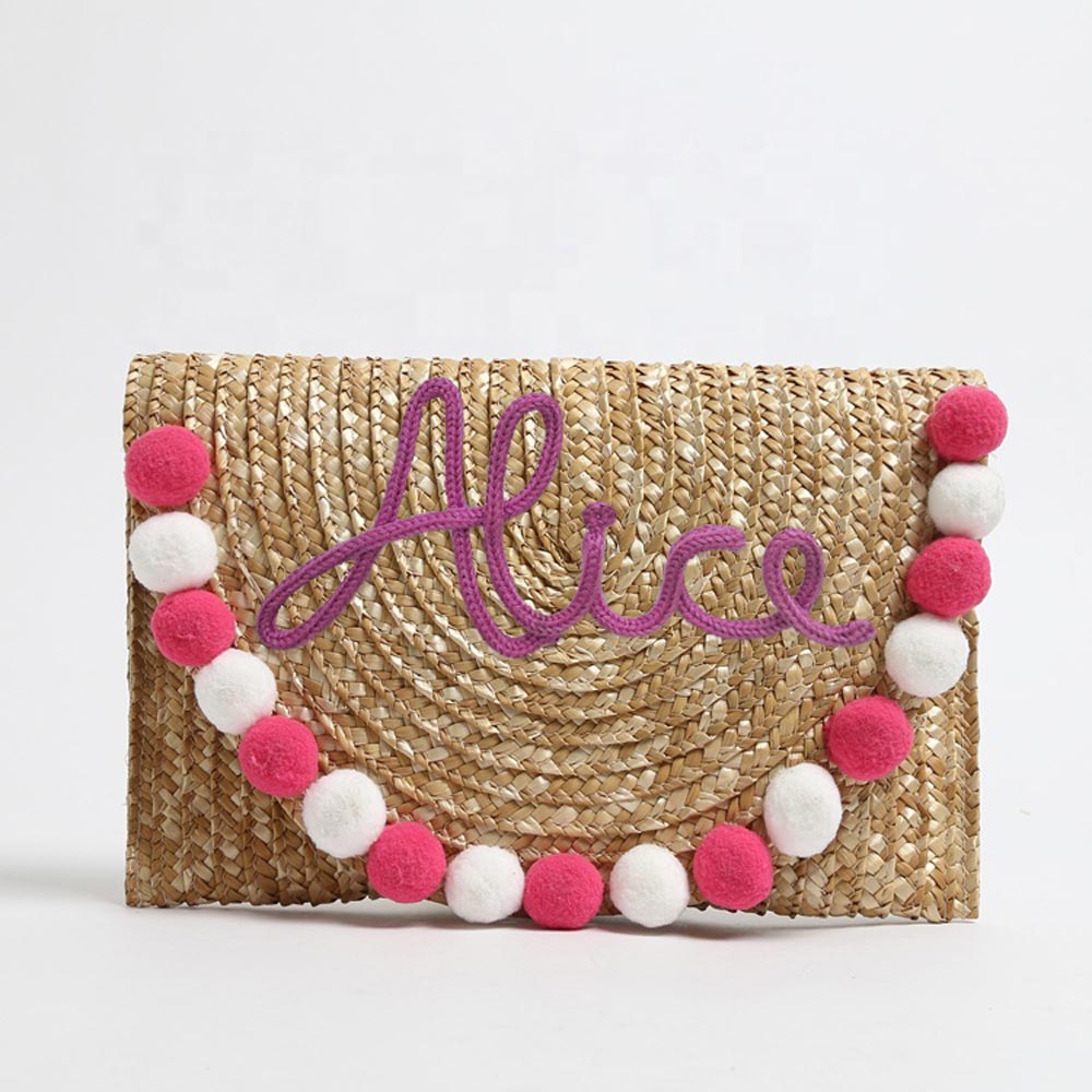 Pochette in paglia Ibiza con scritta personalizzata e pon pom bianchi/rosa