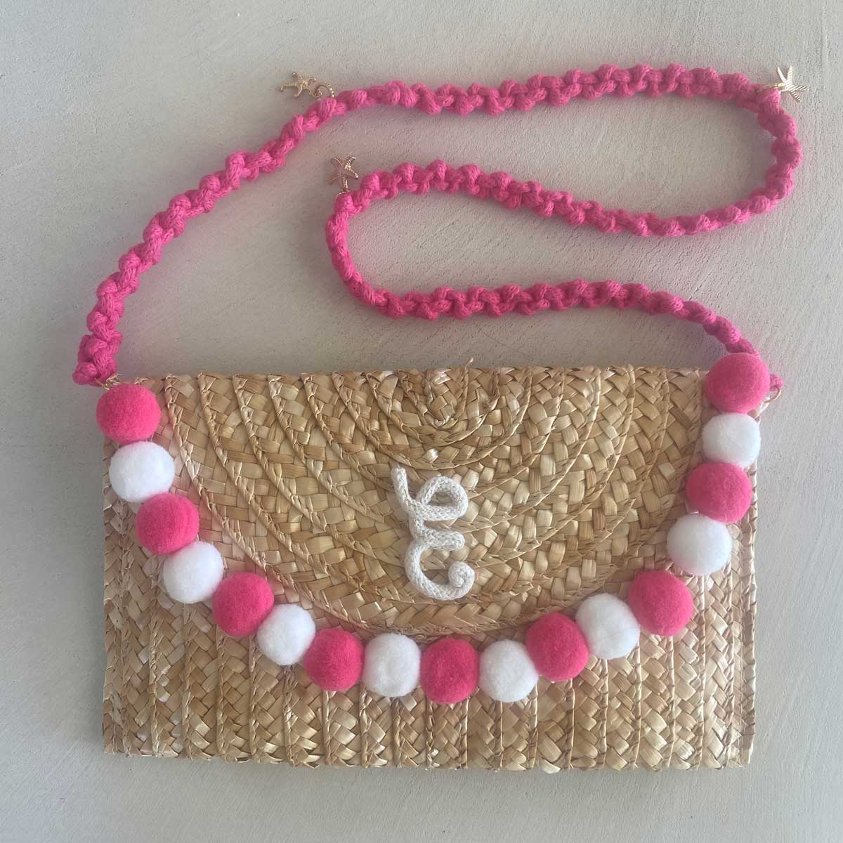 Pochette in paglia Ibiza con scritta personalizzata e pon pom bianchi/rosa