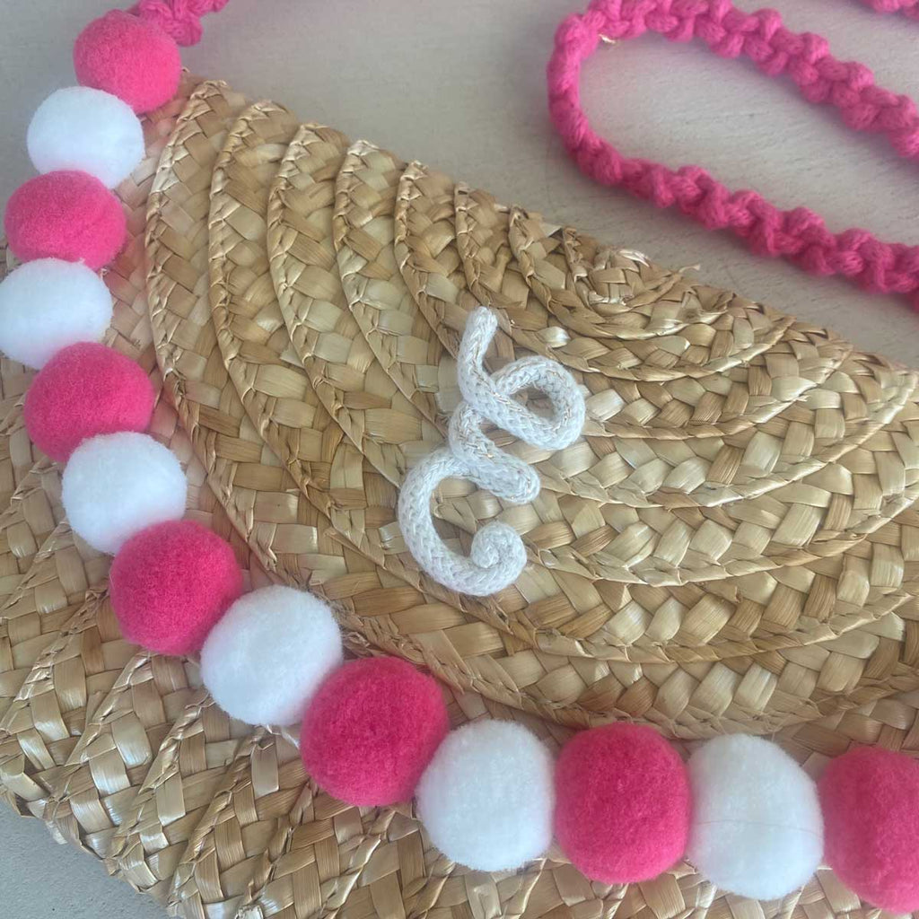 Pochette in paglia Ibiza con scritta personalizzata e pon pom bianchi/rosa